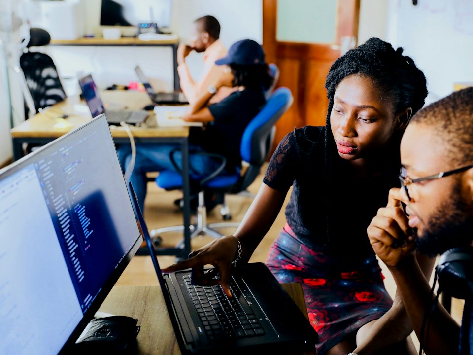 Two engineers reviewing code together at a screen